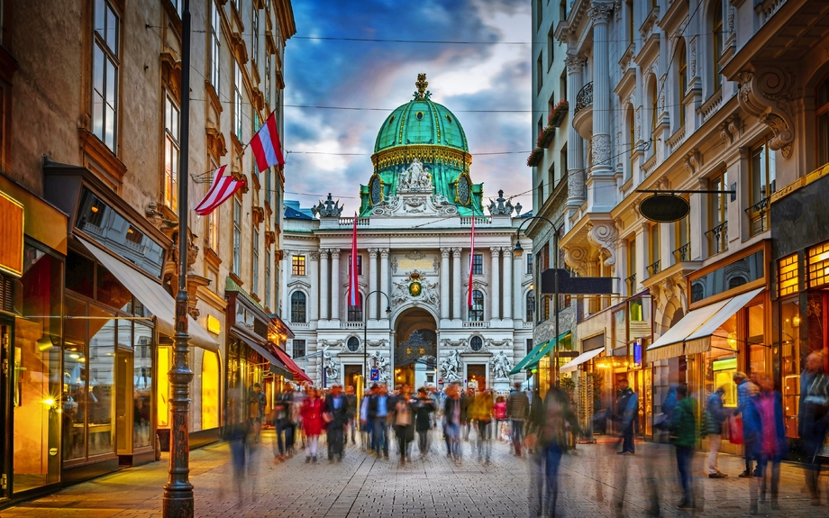 The pedestrian zone Herrengasse with a view towards imperial Hofburg palace in Vienna, Austria.